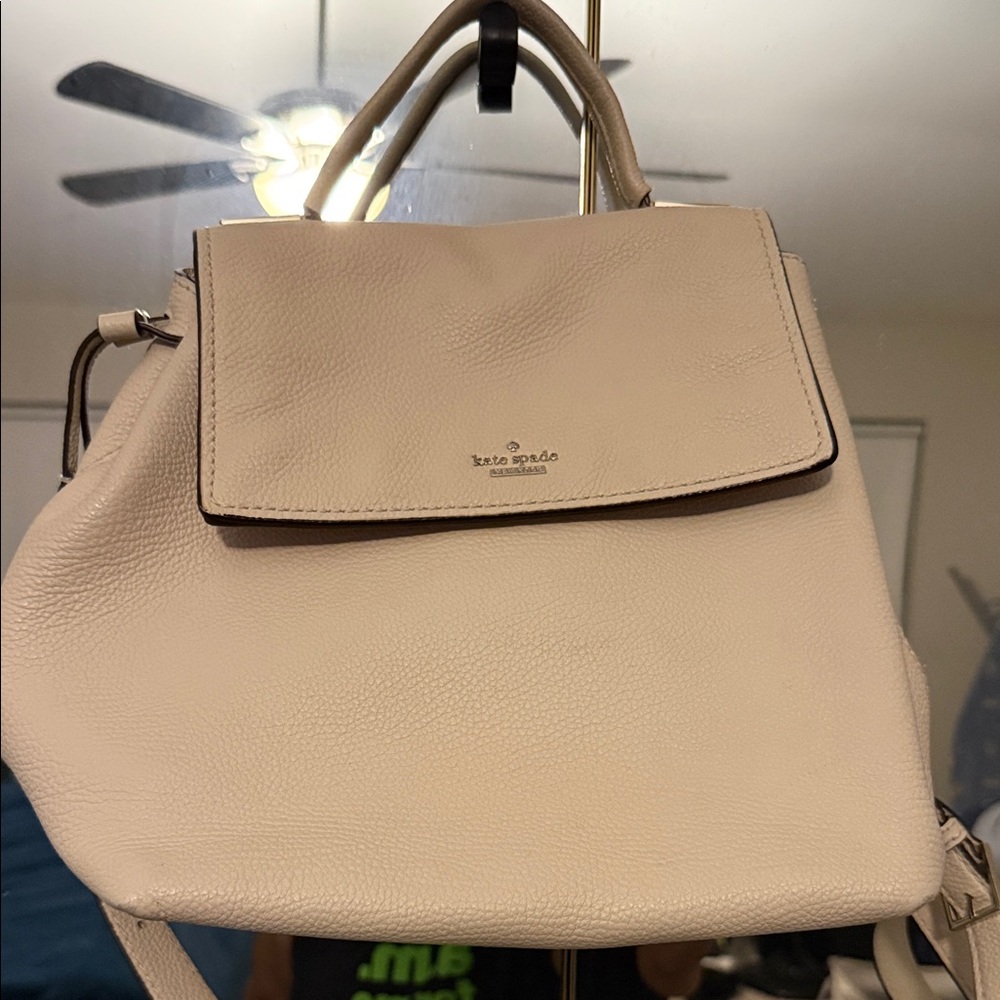 Kate Spade creamLeather Backpack one of the straps have a small tear